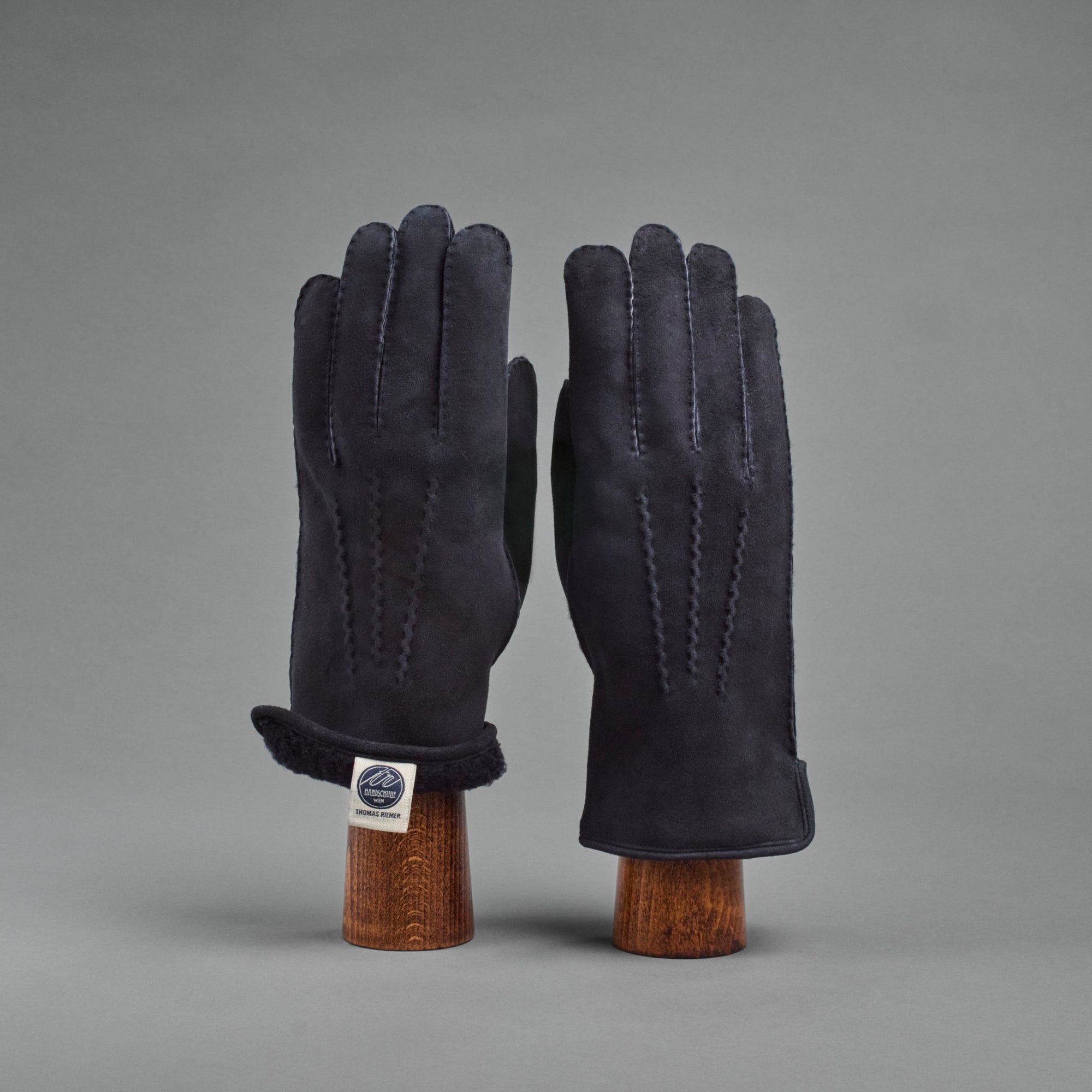 Herrenhandschuhe aus dunkelblauem gelocktem Lammfell